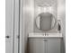 Bathroom featuring a vanity with sink, round mirror, lighting fixture and decorative beadboard at 2323 Tidewatch Way, North Myrtle Beach, SC 29582