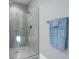Modern bathroom features a glass-enclosed shower with neutral tile and a towel rack with folded towels at 2323 Tidewatch Way, North Myrtle Beach, SC 29582
