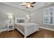 Comfortable bedroom with hardwood floors, shiplap wall, lamps and plantation shutters at 2323 Tidewatch Way, North Myrtle Beach, SC 29582