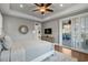 Neutral bedroom design featuring hardwood floors, tray ceilings, access to the lanai and a ceiling fan at 2323 Tidewatch Way, North Myrtle Beach, SC 29582