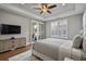 Bright bedroom features hardwood floors, neutral paint, a ceiling fan and access to the lanai at 2323 Tidewatch Way, North Myrtle Beach, SC 29582