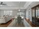 Bright dining room featuring hardwood floors, modern lighting fixture and large windows with plantation shutters at 2323 Tidewatch Way, North Myrtle Beach, SC 29582