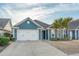 Charming single Gathering home with blue siding, a two-car garage and well-maintained landscaping at 2323 Tidewatch Way, North Myrtle Beach, SC 29582