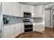Well-equipped kitchen with white cabinets, stainless steel appliances and tile backsplash at 2323 Tidewatch Way, North Myrtle Beach, SC 29582