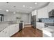 Bright kitchen featuring white cabinets, stainless steel appliances, and granite countertops at 2323 Tidewatch Way, North Myrtle Beach, SC 29582