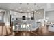 Kitchen featuring white cabinetry, stainless steel appliances, a breakfast bar and hardwood floors at 2323 Tidewatch Way, North Myrtle Beach, SC 29582
