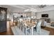 Open concept living room with hardwood floors, a large dining table, and a modern kitchen at 2323 Tidewatch Way, North Myrtle Beach, SC 29582