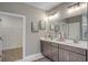 Modern bathroom featuring a double vanity, decorative art, and a large mirror with great lighting at 2520 Brescia St., Myrtle Beach, SC 29579