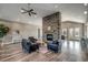 Inviting lounge area featuring comfortable seating, a stone fireplace, and a modern ceiling fan at 2520 Brescia St., Myrtle Beach, SC 29579