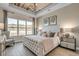 Serene main bedroom with tray ceiling, plush bed, and picturesque window view; complemented by elegant decor at 2520 Brescia St., Myrtle Beach, SC 29579