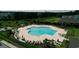 Aerial view of a large community pool surrounded by lounge chairs and lush greenery at 2520 Brescia St., Myrtle Beach, SC 29579