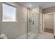 Modern shower enclosed with glass, featuring marble tile and a showerhead, within a bright bathroom setting at 2520 Brescia St., Myrtle Beach, SC 29579