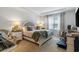 Bright bedroom boasts large windows, tray ceiling, and a cozy sitting area at 2652 Ellesmere Circle, Myrtle Beach, SC 29579