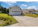 Spacious driveway leading to an attached two-car garage with well maintained yard at 2652 Ellesmere Circle, Myrtle Beach, SC 29579