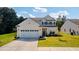 Inviting two-story home with an attached garage, complimented by lush green lawn at 2652 Ellesmere Circle, Myrtle Beach, SC 29579