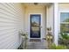 Inviting front door with a decorative wreath, complemented by potted plants at 2652 Ellesmere Circle, Myrtle Beach, SC 29579