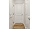Hallway featuring three white doors and wood-look flooring at 2652 Ellesmere Circle, Myrtle Beach, SC 29579