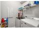 Laundry room includes a side-by-side washer and dryer and overhead shelving at 2652 Ellesmere Circle, Myrtle Beach, SC 29579