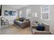 Living room with neutral-colored sofa, chair, side tables, and bright windows at 2652 Ellesmere Circle, Myrtle Beach, SC 29579