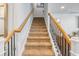 Carpeted stairway featuring wood and iron railing leading to the upper level of the home at 2652 Ellesmere Circle, Myrtle Beach, SC 29579
