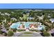 Aerial view of a community featuring a large pool area surrounded by mature trees and lovely single-Gathering homes at 308 Starlit Way, Myrtle Beach, SC 29579