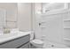 Well-lit bathroom with a gray vanity, toilet, and shower featuring a white shower stall at 308 Starlit Way, Myrtle Beach, SC 29579