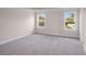 A bedroom with carpet and two windows offering natural light at 308 Starlit Way, Myrtle Beach, SC 29579