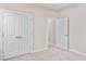 Neutral bedroom with carpet, closet with folding doors, and open door to another room at 308 Starlit Way, Myrtle Beach, SC 29579
