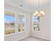 Dining area featuring a chandelier and sunlit windows providing neighborhood views at 308 Starlit Way, Myrtle Beach, SC 29579