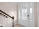 Bright entryway featuring a white front door, sidelights, and staircase with wooden handrail at 308 Starlit Way, Myrtle Beach, SC 29579