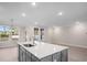 A kitchen showcasing a large island with gray cabinets, white countertops and wood flooring at 308 Starlit Way, Myrtle Beach, SC 29579