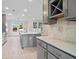 Modern kitchen with gray cabinetry, an island with sink, white countertops, and tiled backsplash at 308 Starlit Way, Myrtle Beach, SC 29579
