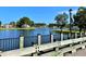 Scenic view of a tranquil pond reflecting surrounding homes, captured from a wooden walkway with black metal railing at 308 Starlit Way, Myrtle Beach, SC 29579