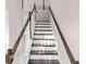 Staircase with white risers, dark treads, and a wooden handrail leading to the upper level at 308 Starlit Way, Myrtle Beach, SC 29579