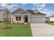 Charming single-Gathering home with a well-manicured lawn, two-car garage, and inviting covered front porch at 3087 Dover Branch Dr., Little River, SC 29566