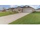 Attractive home with a two-car garage, well-kept lawn, and a concrete driveway, ideal for suburban living at 3087 Dover Branch Dr., Little River, SC 29566