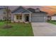 Charming single-Gathering home with a well-manicured lawn, two-car garage, and inviting covered front porch at 3087 Dover Branch Dr., Little River, SC 29566