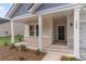 Inviting front porch with white columns and brick accents, perfect for enjoying the outdoors at 3087 Dover Branch Dr., Little River, SC 29566