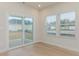Bright living room features sliding glass doors, large windows, and hardwood floors at 3087 Dover Branch Dr., Little River, SC 29566
