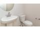 A classic powder room features a pedestal sink, toilet and a decorative round mirror at 3087 Dover Branch Dr., Little River, SC 29566