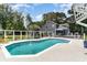 Aerial shot of backyard pool featuring a fountain, outdoor seating, and mature trees at 316 13Th Ave. N, Surfside Beach, SC 29575