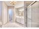 Well-lit bathroom with double sinks, a glass shower, and tile flooring at 3736 Brookhill Dr., Myrtle Beach, SC 29588