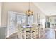 Dining room with a chandelier, bay window, a pelican painting, and hardwood floors at 3736 Brookhill Dr., Myrtle Beach, SC 29588