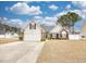 Inviting home with a spacious front yard, a red door, and a two-car garage at 3736 Brookhill Dr., Myrtle Beach, SC 29588