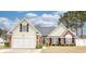 Charming home featuring a manicured lawn, brick accents, and an attached two-car garage at 3736 Brookhill Dr., Myrtle Beach, SC 29588
