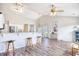 Open-concept living space featuring a breakfast bar, hardwood floors, and lots of natural light at 3736 Brookhill Dr., Myrtle Beach, SC 29588