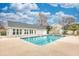 Community pool with clear blue water surrounded by a concrete deck and well-maintained building at 3736 Brookhill Dr., Myrtle Beach, SC 29588