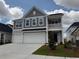 Charming two-story home boasts a two-car garage and a welcoming front porch at 4043 Bucolic Loop, Myrtle Beach, SC 29588