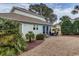 Charming backyard with a patio, outdoor furniture, and lush landscaping creates a relaxing outdoor living space at 405 Banyan Place, North Myrtle Beach, SC 29582