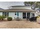 Spacious backyard featuring a patio with multiple seating areas, perfect for entertaining at 405 Banyan Place, North Myrtle Beach, SC 29582
